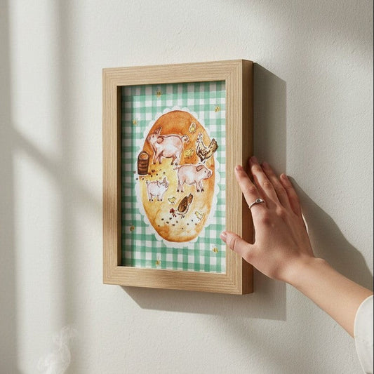 School Bus Studio A4 pigs art print in an oak frame featuring farm animals on a green gingham background.