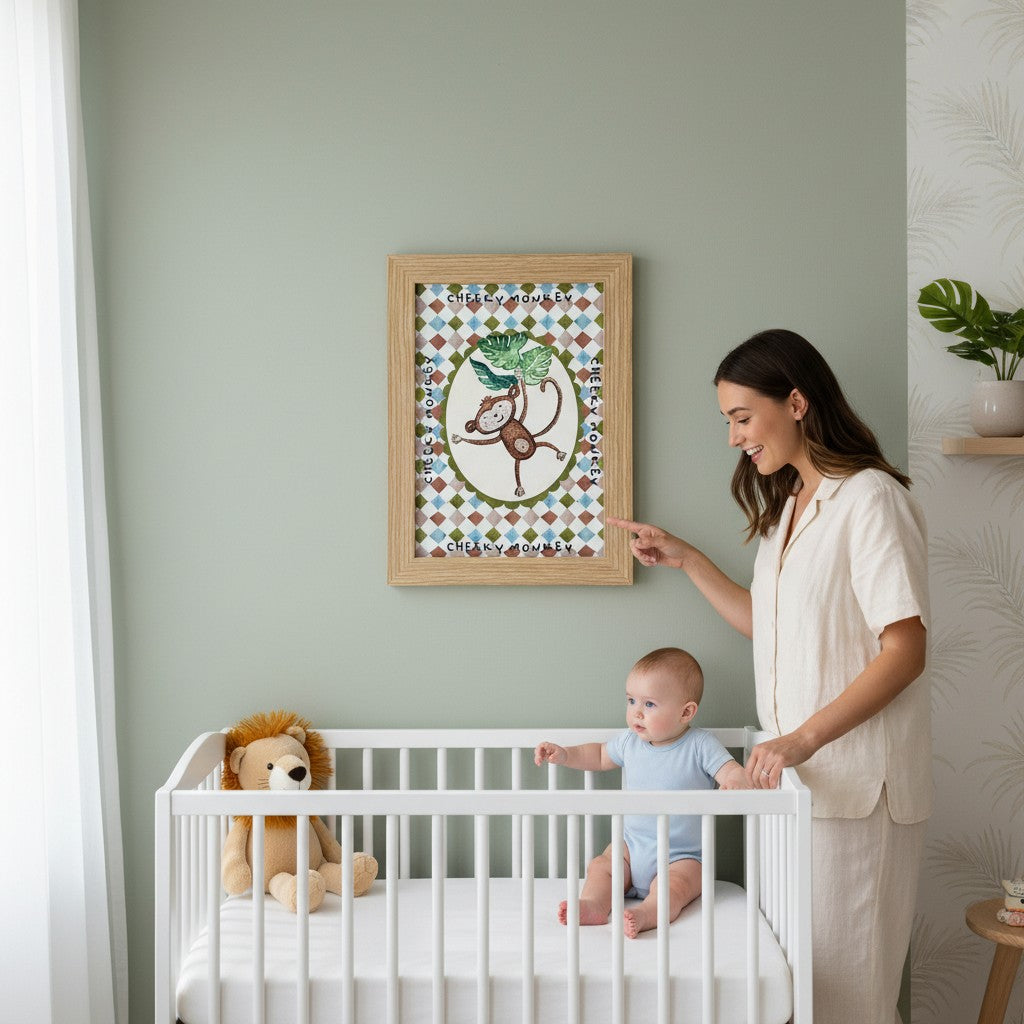 School Bus Studio Cheeky Monkey A4 art print in oak frame hanging above a baby in a white crib in a nursery.