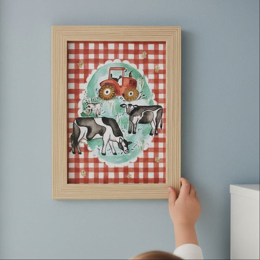School Bus Studio A4 farm print featuring cows and a tractor on red gingham background in an oak finish frame.