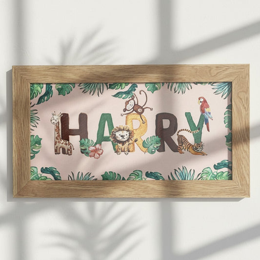 School Bus Studio custom safari name print in an oak frame with watercolor jungle animals on pink background.