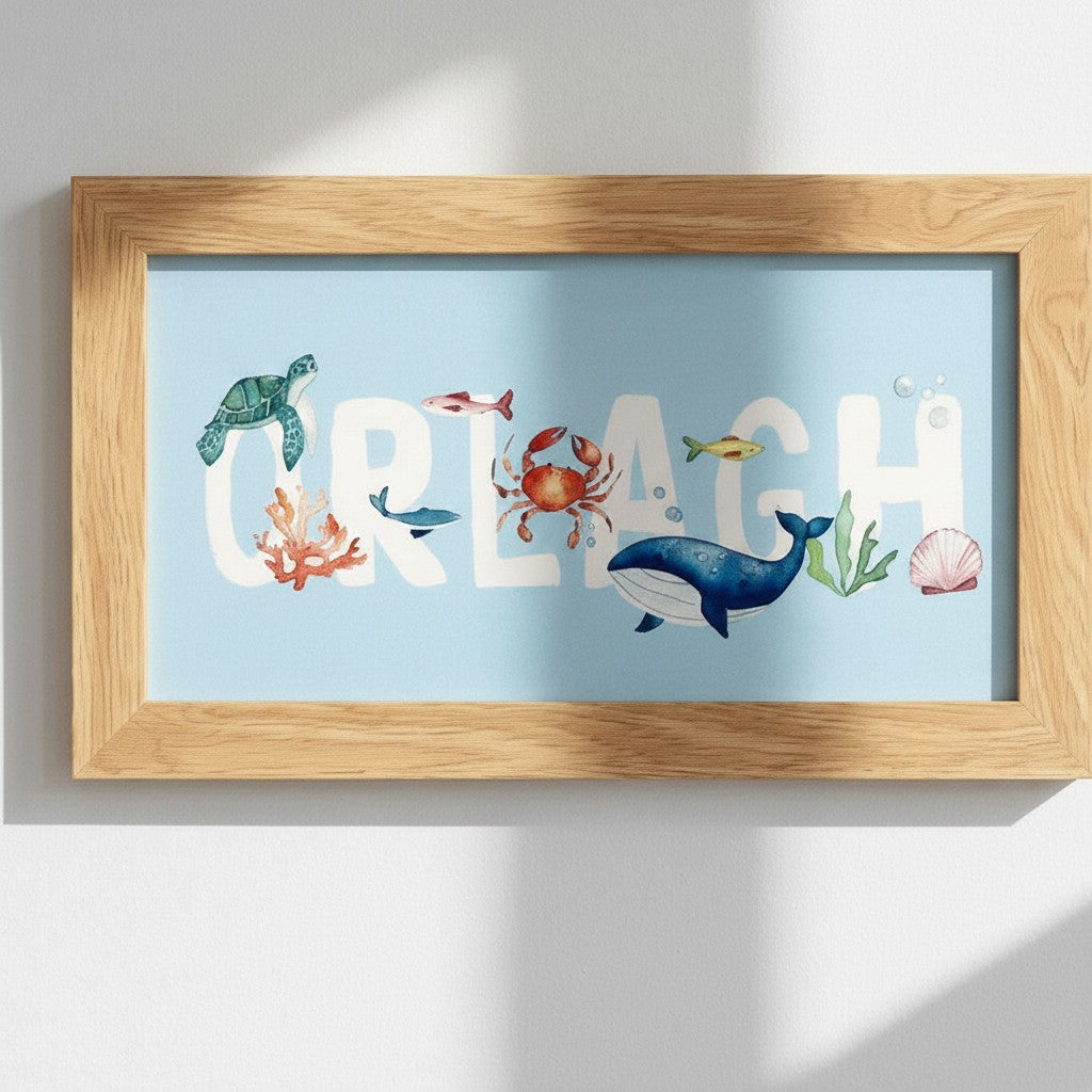 School Bus Studio custom Under the Sea name print in an oak frame featuring watercolor sea creatures on blue card.